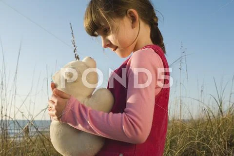 Young Girl Holding Stuffed Toy Polar Bear Cub