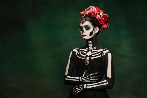 Young girl in the image of Santa Muerte, Saint death or Sugar skull with bright Stock Photos