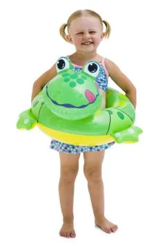 Young girl with inflatable flotation device around waist Stock Photos