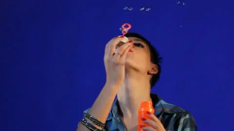  young girl inflating colorful soap bubbles Stockbeeldmateriaal 12261453