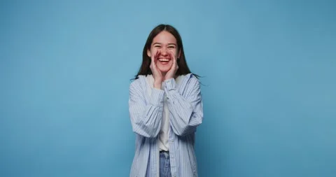Young girl with a joyful expression, showcasing her excitement with hands o.. Stock Footage 314336670