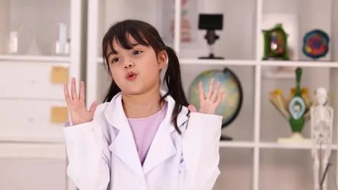 Young Girl in Lab Coat Gesturing During Science Lesson Stock Footage 342577589