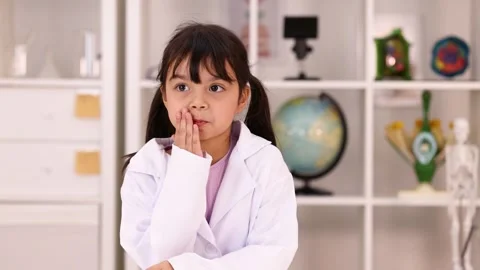 Young Girl in Lab Coat Thinking in Science Classroom Stock Footage 342577591