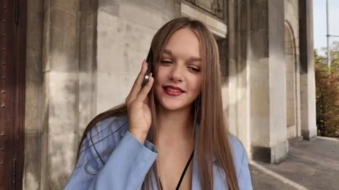 A young girl laughed while chatting on her mobile phone with her sister Stock Footage 285446734