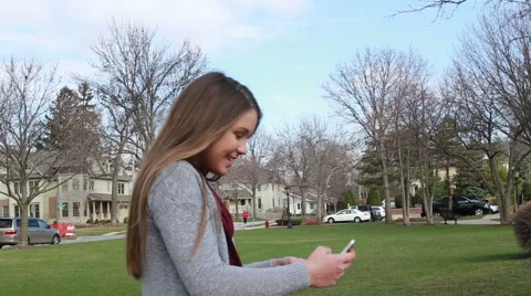 Young girl laughing while texting, video Stock Footage 61469248