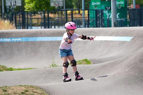 Young Girl Learning Balance While Inline Skating on Pump Track Stock Photos