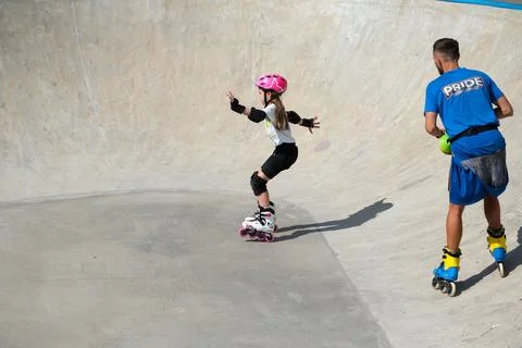 Young Girl Learning Inline Skating With Coach at Skatepark Stock Photos