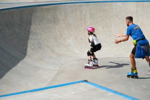 Young Girl Learning Inline Skating With Coach Stock Photos