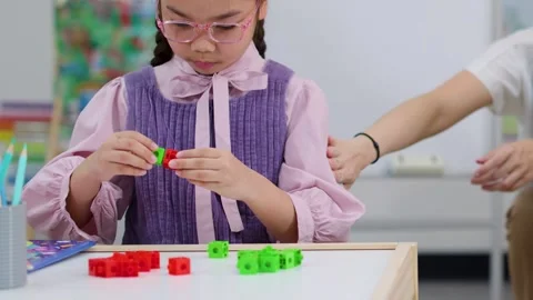 Young Girl Learning Mathematics with Colorful Interlocking Stock Footage 327770891