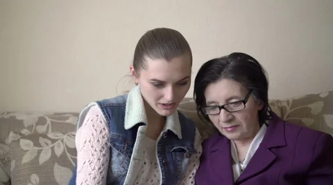 Young girl learning older woman how to use tablet. Stock Footage
