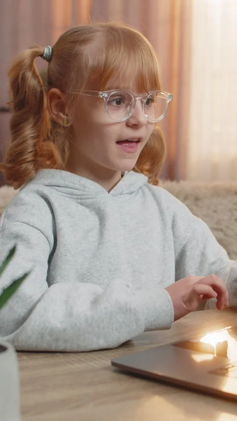 Young girl learning programming on laptop, celebrating in excitement after Video stock 314743204