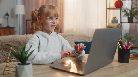 Young girl learning programming on laptop, celebrating in excitement after Stock Footage 347048189