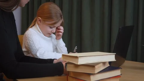 Young girl learning with teacher using laptop and books Stock Footage 317818667