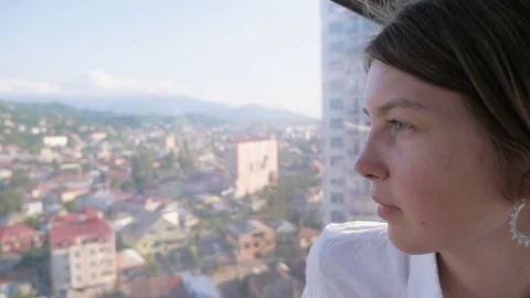 Young girl look through the window from cabin in rope way, Batumi, Georgia Stock Footage 83991153
