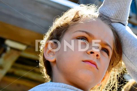 Young Girl Looking Off in the Distance on a Bright, Sunny Day Stock Photos