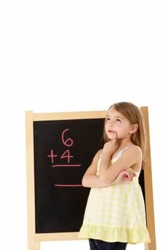 Young Girl Looking Thoughtful Next To Blackboard Stock Photos