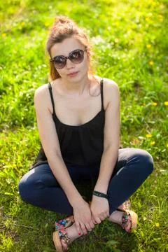 A young girl looks at the camera while walking in the park Stock Photos