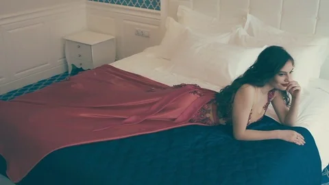 Young girl lying on bed Stock Footage 73034309