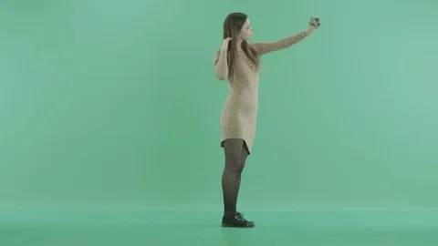 A young girl makes selfies with the phone Stock Footage