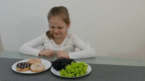 Young Girl Making Choice Between Healthy And Junk Food 002 Stock Footage 73889348