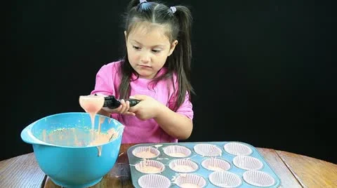 Young girl making cupcakes Stock Footage
