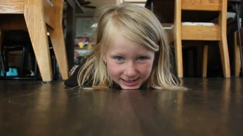 Young Girl Making Faces on Floor Stock Footage 130757721