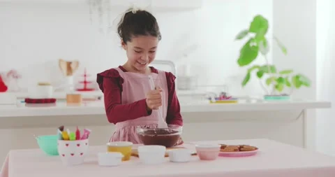 Young girl making sweets in the kitchen Stock Footage 239408108
