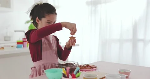 Young girl making sweets in the kitchen Stock Footage 239408210