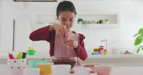 Young girl making sweets in the kitchen Video stock 239408281