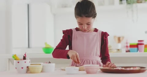 Young girl making sweets in the kitchen Stock Footage 239408313