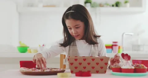 Young girl making sweets in the kitchen Stock Footage 239408464