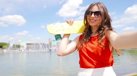 Young girl making video selfie and having fun in the park. Lifestyle selfie Stock Footage