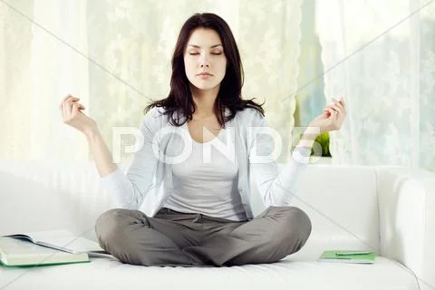 Young girl meditating at home Stock Photos