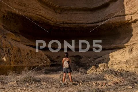 Young girl in the middle of the canyons of the Namibe Desert. Africa. Angola. Stock Photos