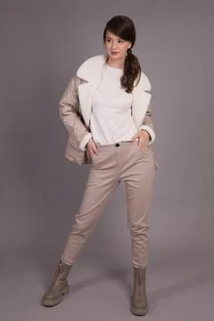 A young girl model posing at the camera demonstrates clothes in different pos Foto stock