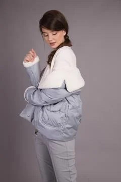 A young girl model posing at the camera demonstrates clothes in different pos Foto stock
