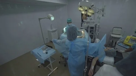 Young girl on the operating table. She is undergoing surgery on gynecology. The Stock Footage 78026869