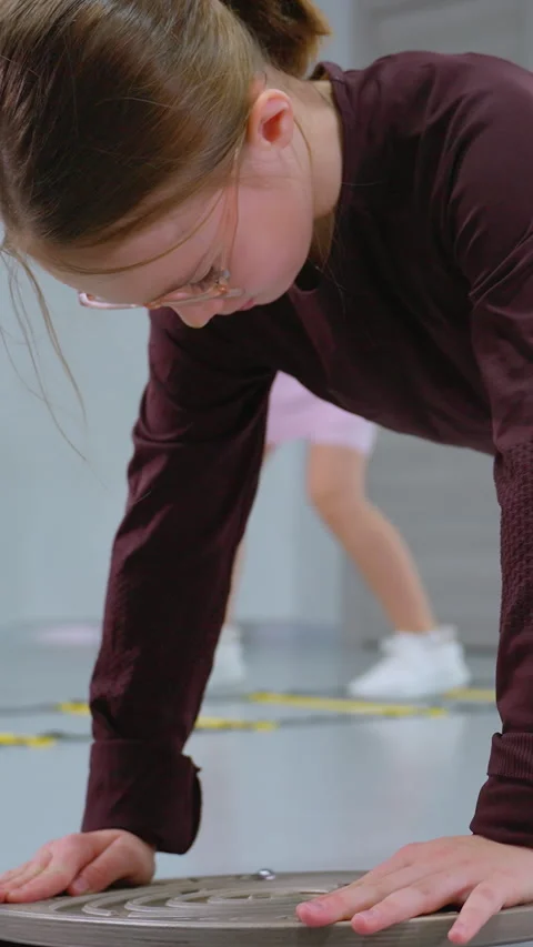 Young Girl Performing Stability Exercise on Balance Board for Strength Training Stock Footage 318735247