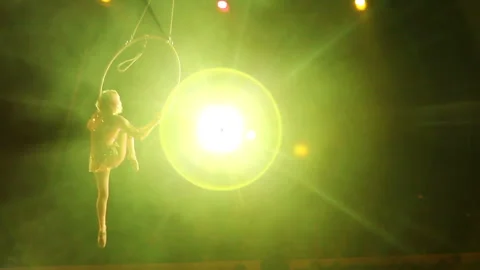 Young girl performs the acrobatic elements in the air ring Video stock 91831649
