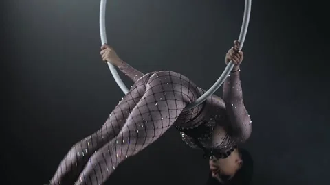Young girl performs the acrobatic elements in the air ring. Slow motion. Closeup Stock Footage 110655140
