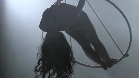 Young girl performs the acrobatic elements in the air ring. Slow motion. Closeup Stock Footage 110655721