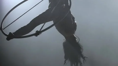 Young girl performs the acrobatic elements in the air ring. Slow motion. Closeup Stock Footage 110656092
