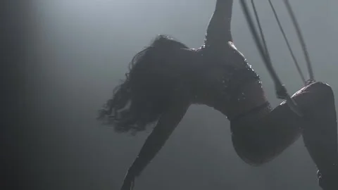 Young girl performs the acrobatic elements in the air ring. Slow motion. Closeup Stock Footage 110656615