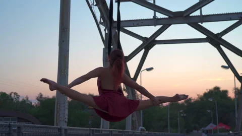 Young girl performs gymnastic elements on air loops. circus artist Stock Footage 155311868
