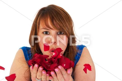 Young girl with petals from roses Stock Photos
