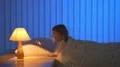 The young girl phone on the bed. Evening night time 4k or 4k+ Resolution