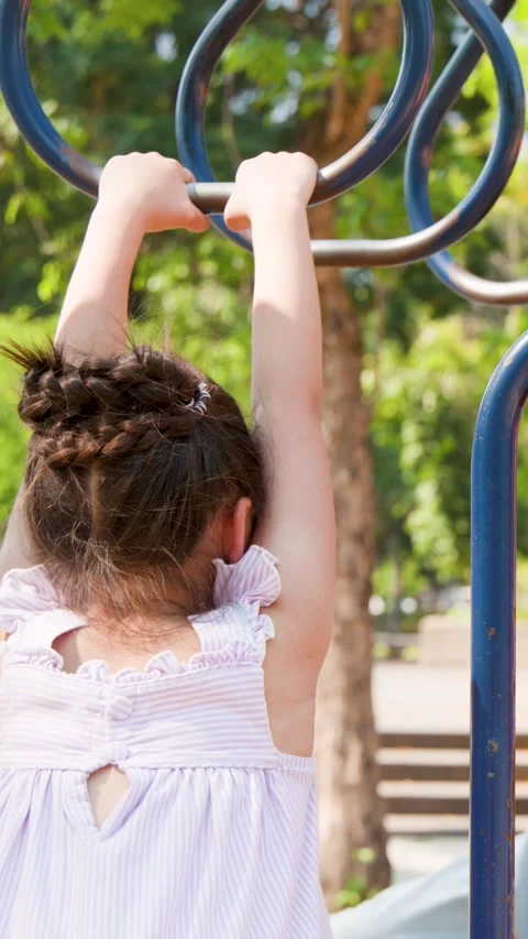 Young Girl Playing on Monkey Bars at Lumpini Park Playground Stock Footage 345194492