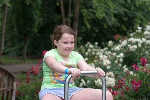 Young girl playing in a park Stock Photos