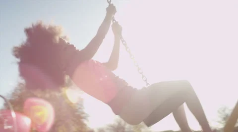 Young girl playing on a zip wire in a park Stock Footage