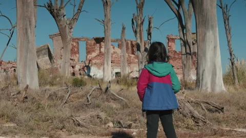 Young Girl Posing Among Trees and Ruins at Epecuen in Daylight Stock Footage 328654540